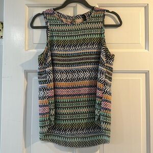Beautiful sleeveless blouse. Most flattering on.